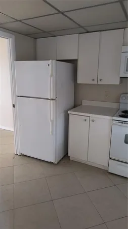 a white refrigerator freezer sitting in a kitchen