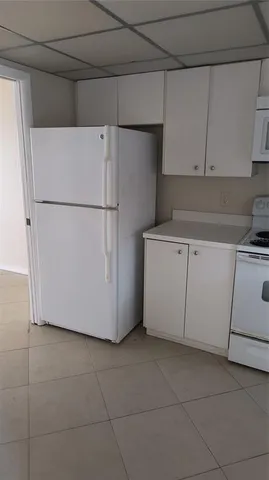 a white refrigerator freezer sitting in a kitchen