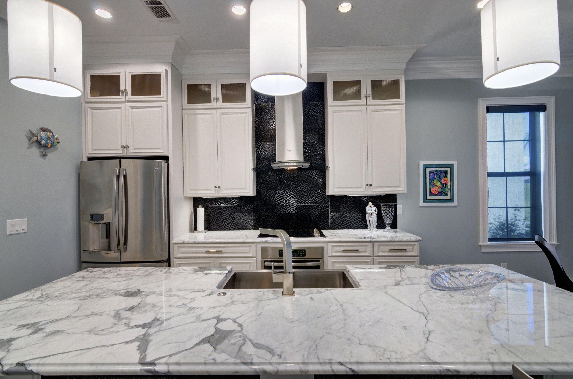 1922 Baytowne Loop Miramar Beach, FL 32550 - Photo 19 of 65 a kitchen with stainless steel appliances kitchen island granite countertop a stove a sink and a refrigerator