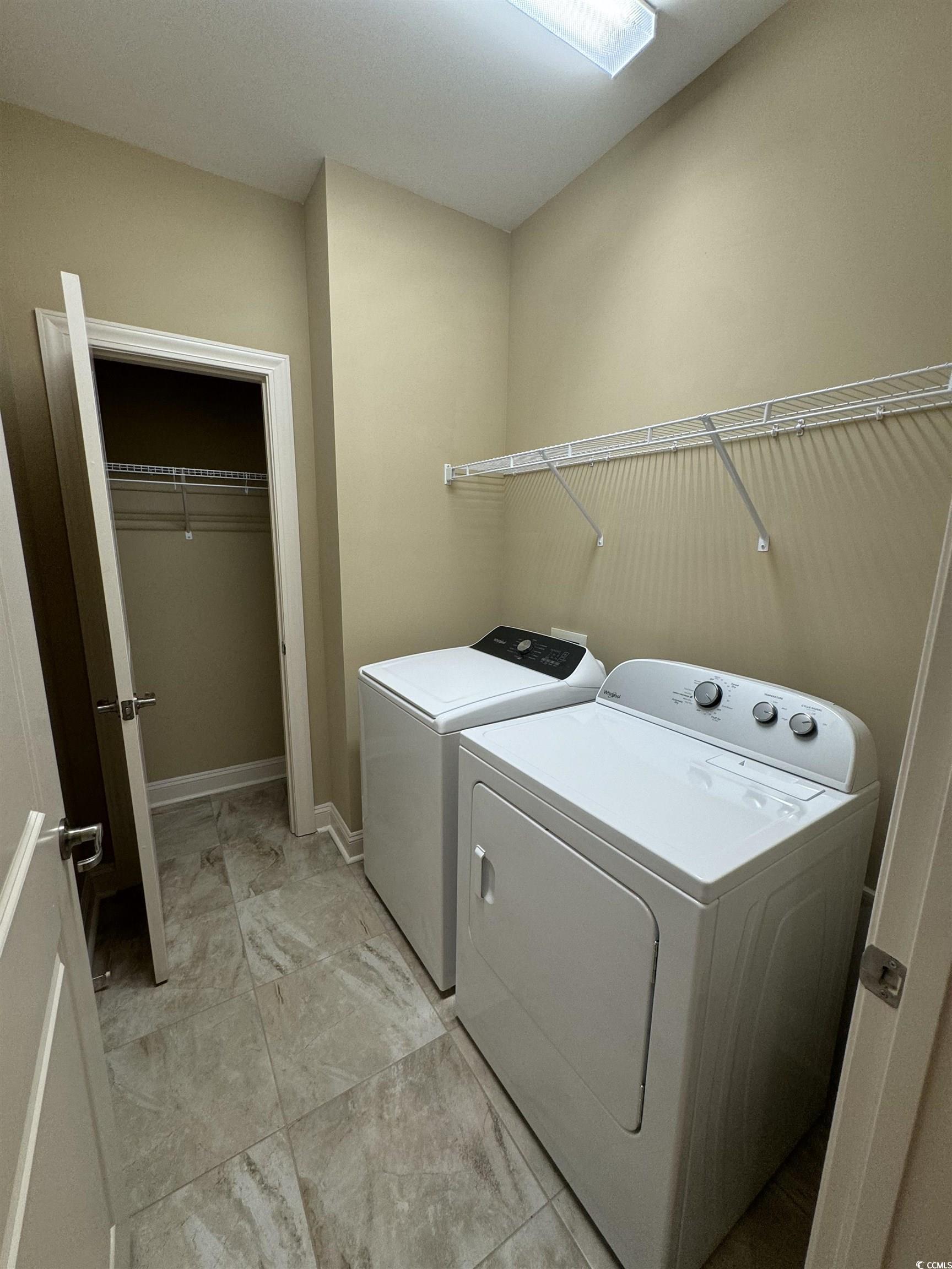 144 Puffin Drive, Unit 2E Pawleys Island, SC 29585 - Photo 7 of 17 Washroom featuring washing machine and clothes dryer and baseboards
