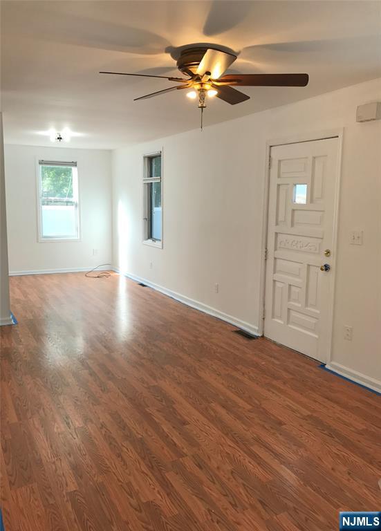 1 Cedar Lane Paramus, NJ 07652 - Photo 7 of 13 a view of an empty room with wooden floor