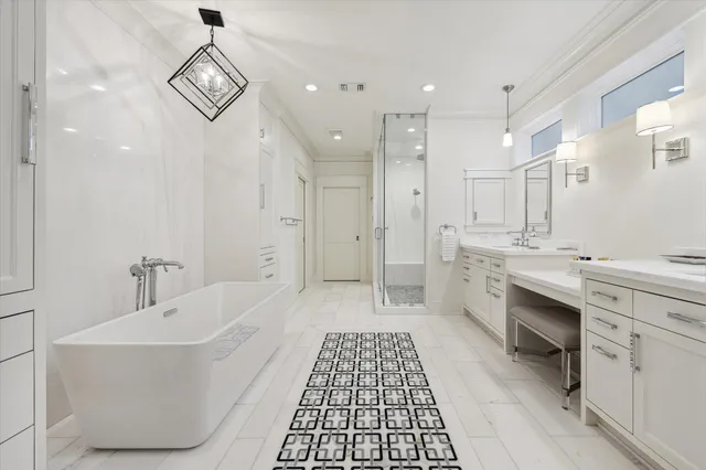 a bathroom with a double vanity sink a toilet a mirror and shower