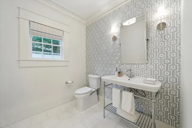 a bathroom with a sink a toilet and a mirror