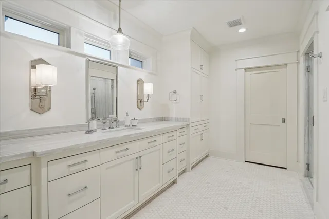 a bathroom with a double vanity sink and a mirror