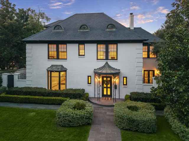 a front view of a house with a garden