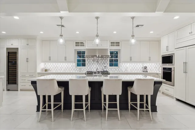 a large kitchen with a table and chairs