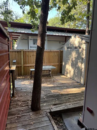 a view of a yard with wooden fence