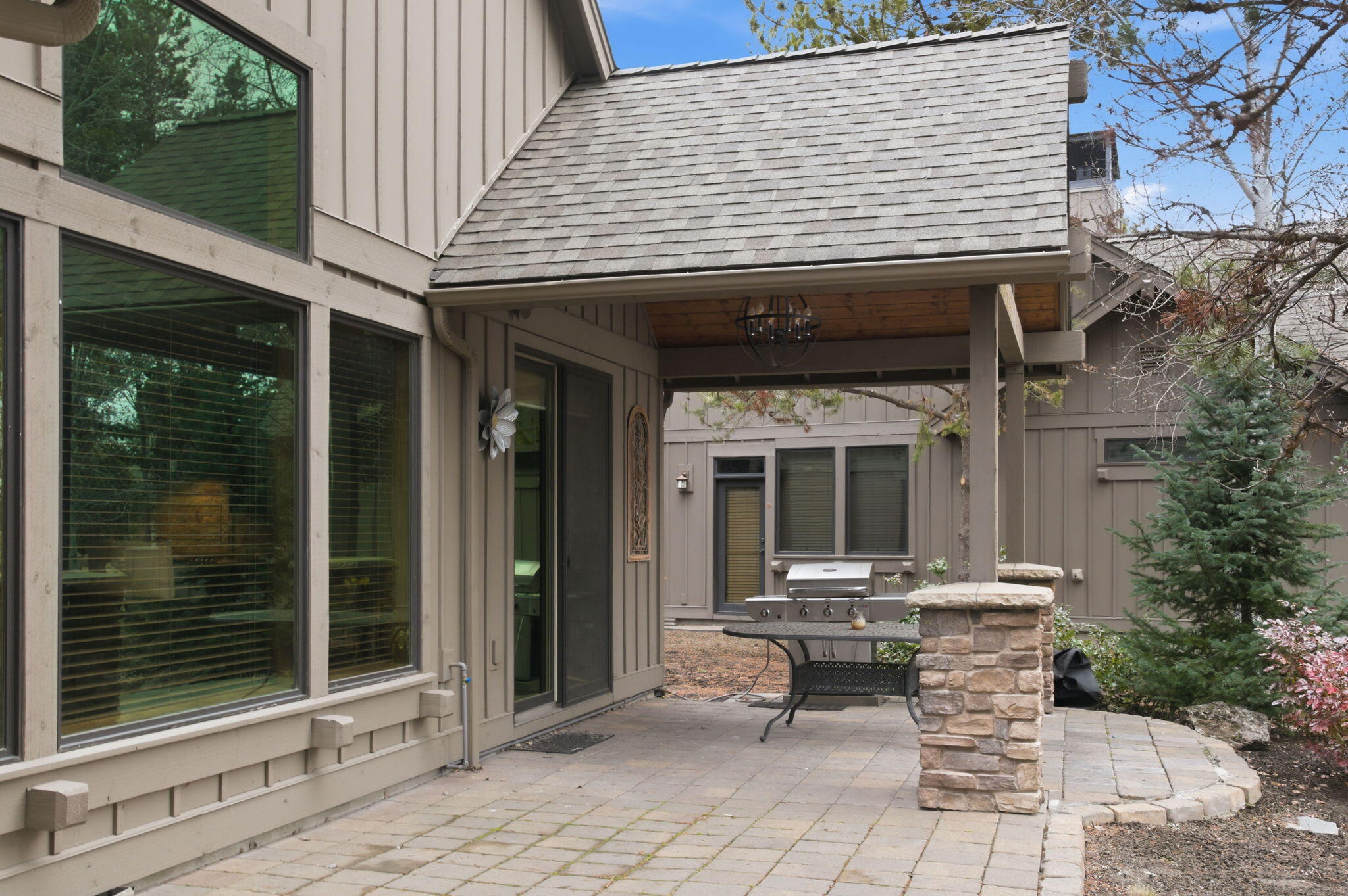 56508 Dancing Rock Loop, Unit 22 Bend, OR 97707 - Photo 51 of 69 a view of a patio with table and chairs and potted plants