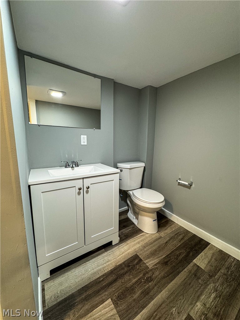 306 Robinson Road Campbell, OH 44405 - Photo 18 of 21 Bathroom with hardwood / wood-style flooring, vanity, and toilet
