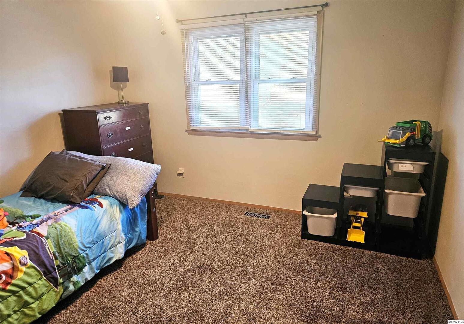 803 Maas Road Quincy, IL 62305 - Photo 12 of 28 a bedroom with a bed and a window