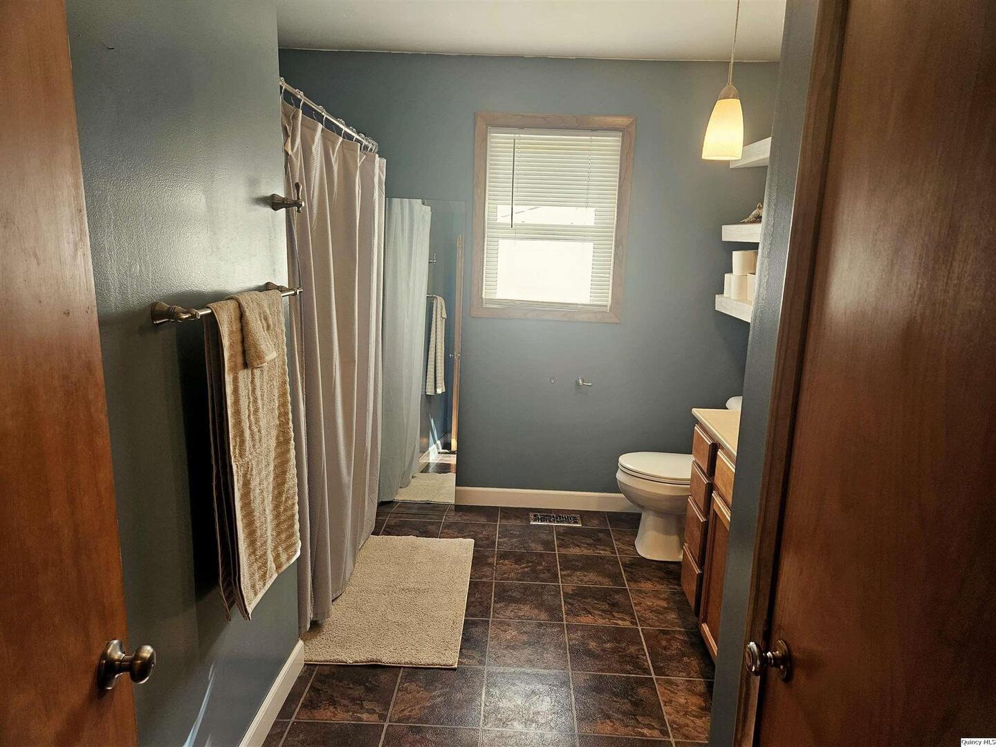 803 Maas Road Quincy, IL 62305 - Photo 16 of 28 a bathroom with a sink toilet and shower