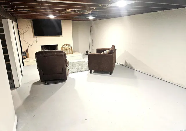 a living room with a flat screen tv and a refrigerator