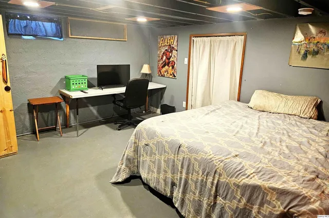 a bedroom with a bed and a table