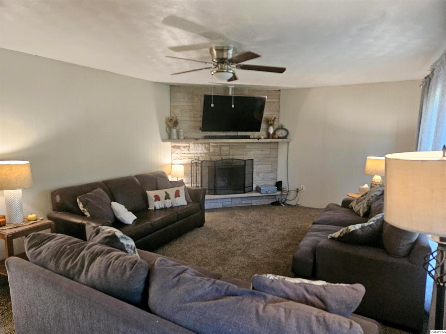 803 Maas Road Quincy, IL 62305 - Photo 2 of 28 a living room with furniture and a fireplace
