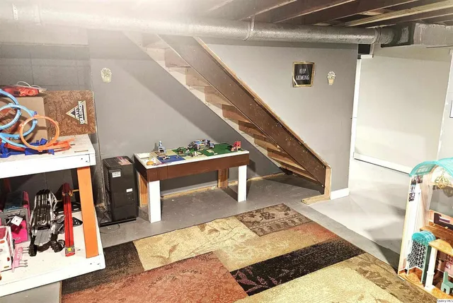 a living room with furniture and a rug