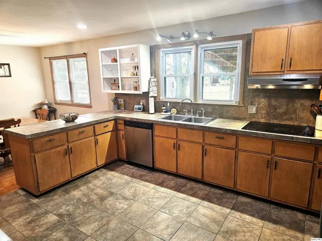 a kitchen with sink cabinets and window