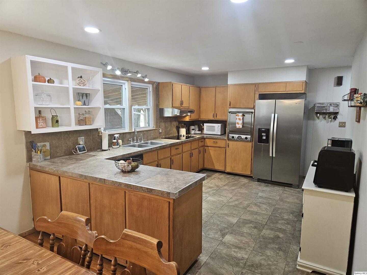 803 Maas Road Quincy, IL 62305 - Photo 8 of 28 a kitchen with stainless steel appliances granite countertop a sink refrigerator and cabinets