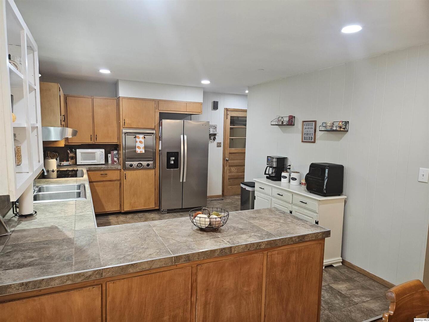 803 Maas Road Quincy, IL 62305 - Photo 9 of 28 a kitchen with stainless steel appliances granite countertop a refrigerator a stove and a sink