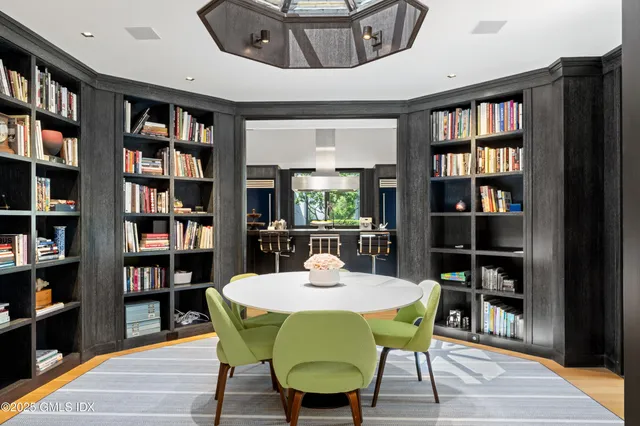 a view of a dining room with furniture and a book shelf