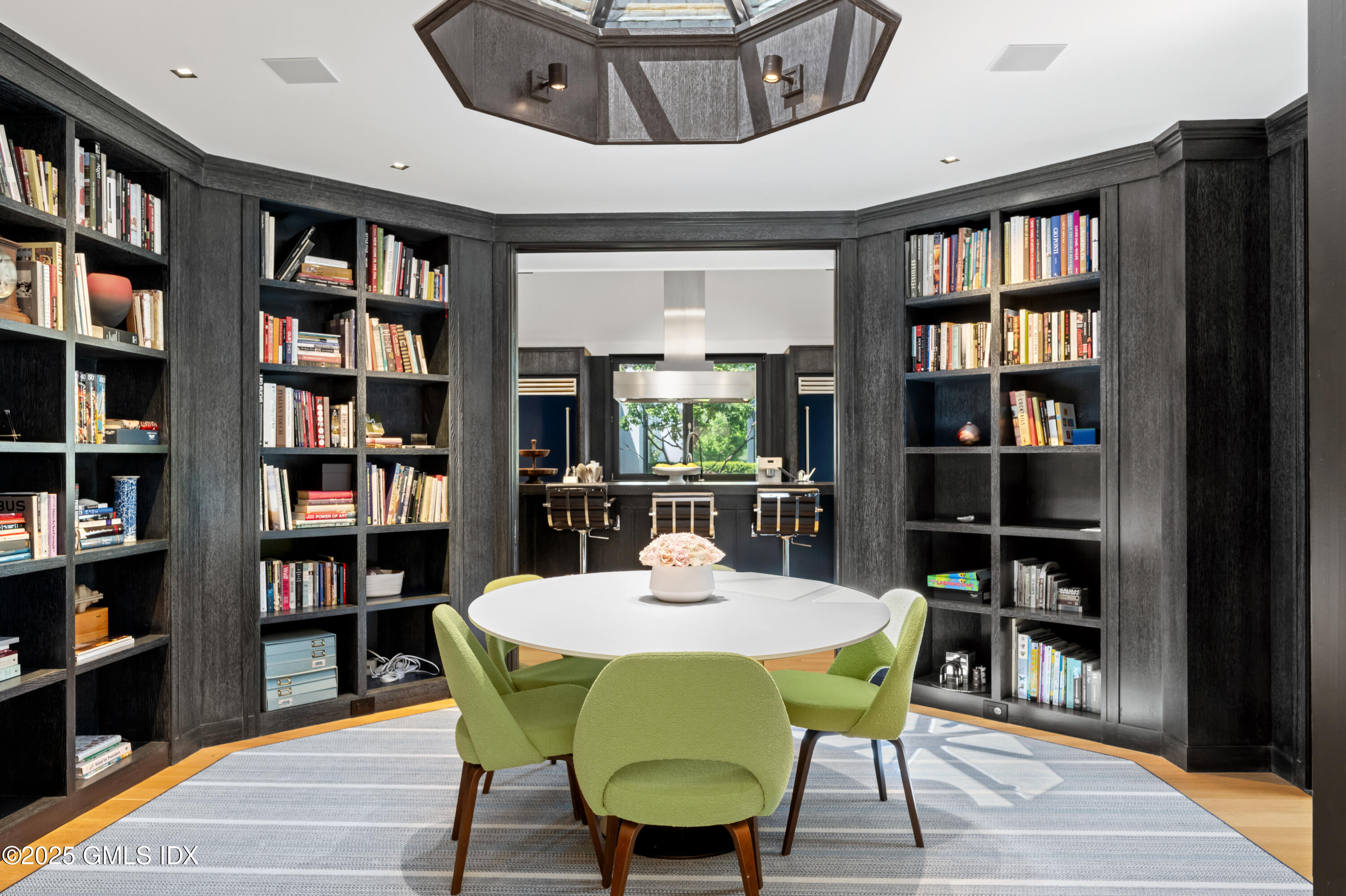 4800 Congress Street Fairfield, CT 06824 - Photo 13 of 37 a view of a dining room with furniture and a book shelf