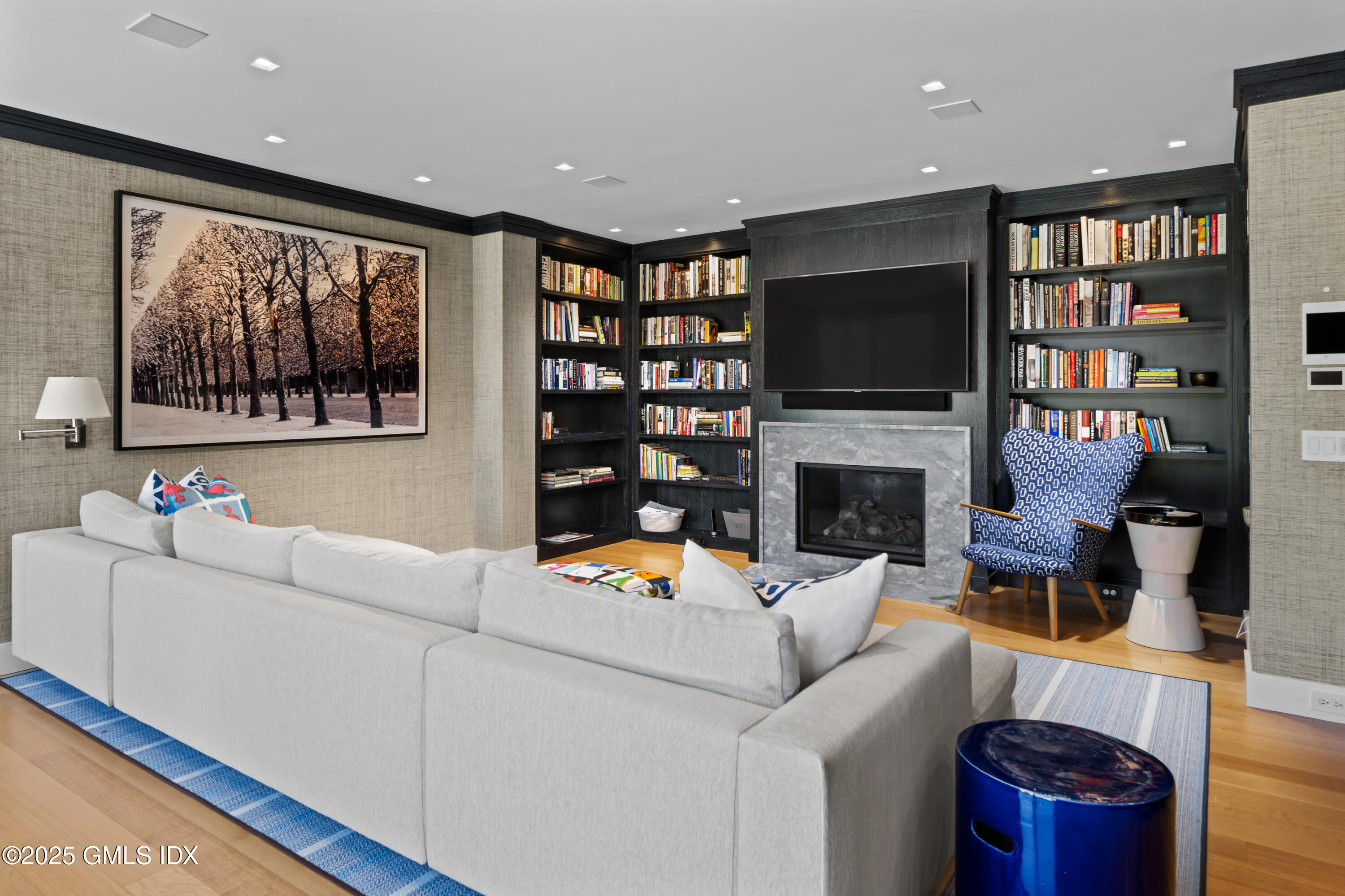 4800 Congress Street Fairfield, CT 06824 - Photo 16 of 37 a living room with furniture a flat screen tv and a bookshelf