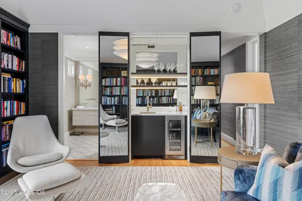 a living room with furniture and a book shelf