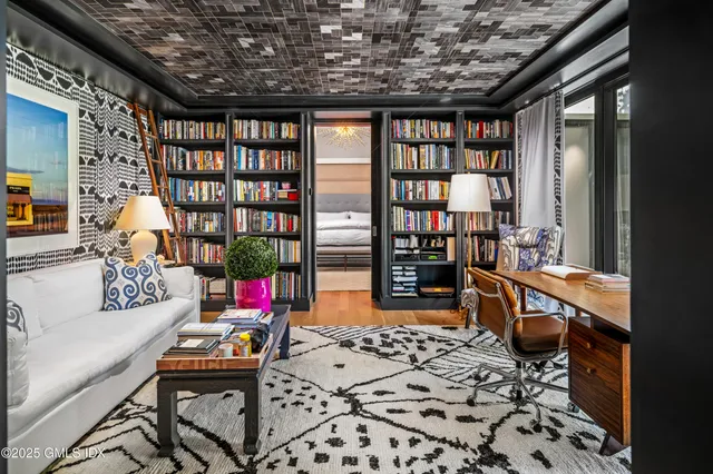 a reading room with furniture and book shelf