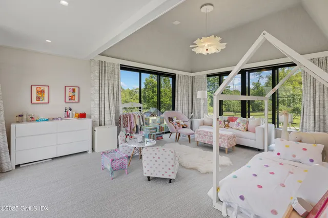 a living room with furniture and large windows