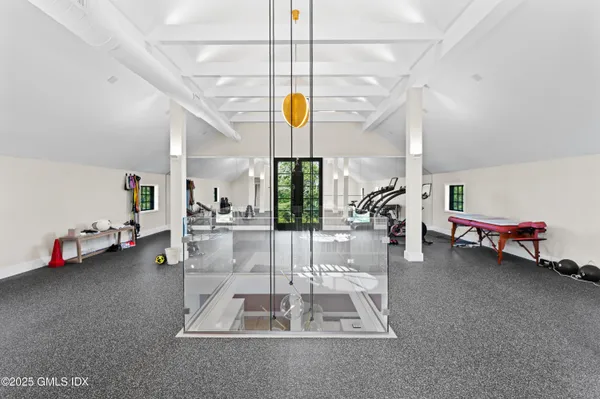 a room with gym equipment and a large window