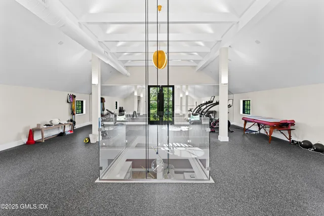 a room with gym equipment and a large window