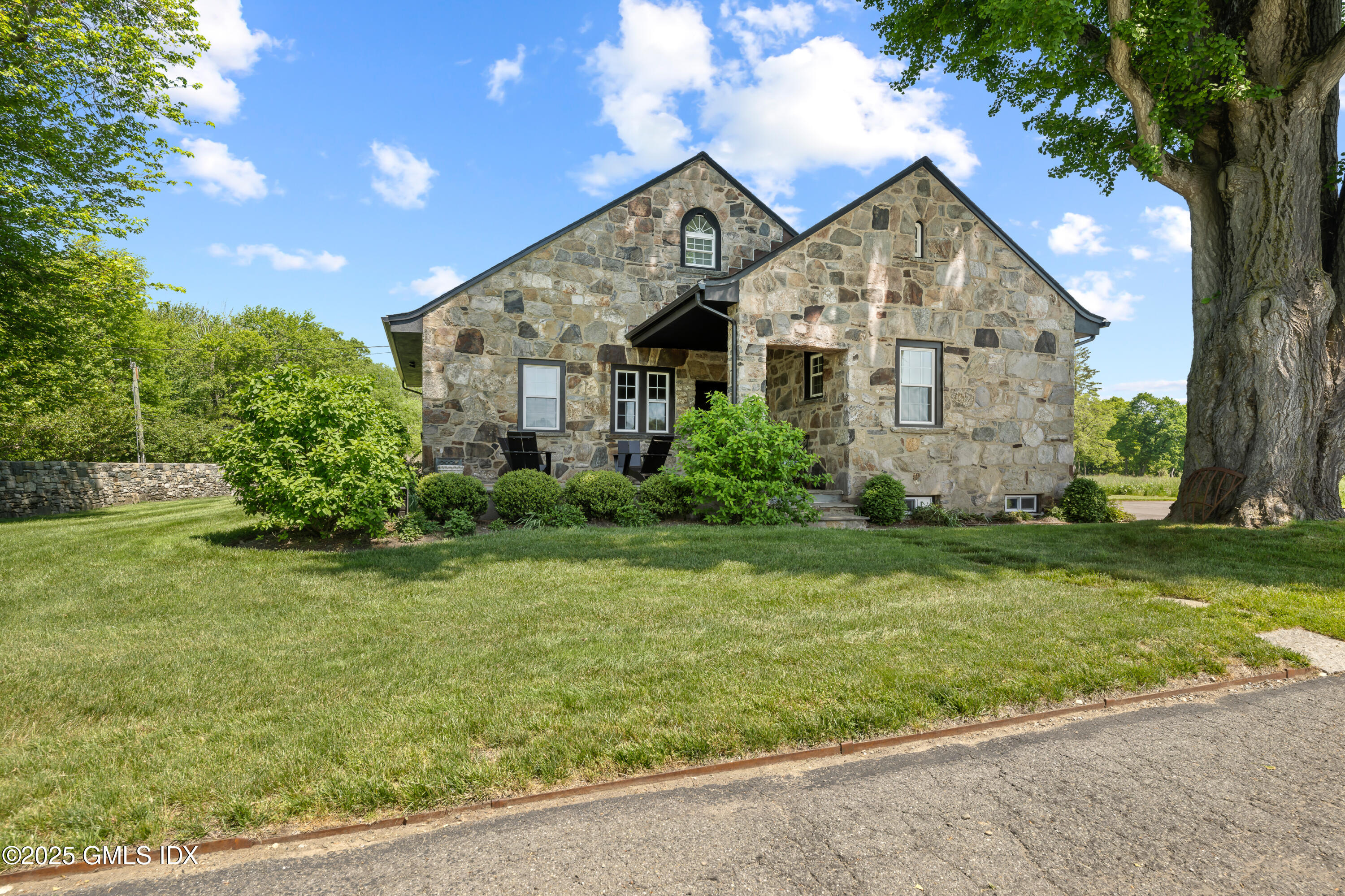 4800 Congress Street Fairfield, CT 06824 - Photo 35 of 37 a front view of house with yard and green space