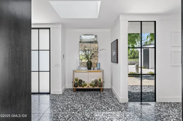 a view of a hallway with windows and stairs