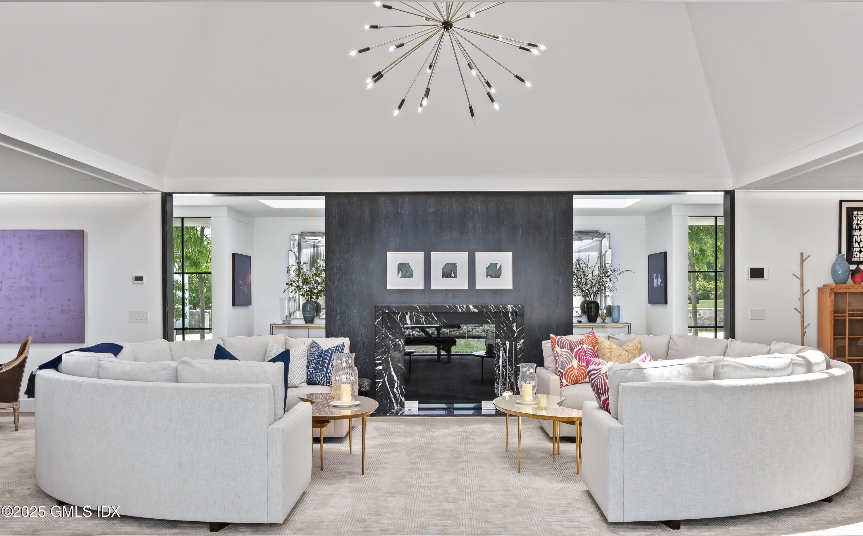 4800 Congress Street Fairfield, CT 06824 - Photo 8 of 37 a living room with couches a fireplace and dining table with wooden floor