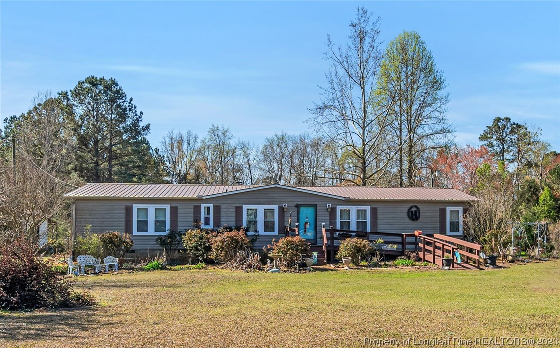 560 Moody Road Cameron, NC 28326 - Photo 1 of 29 a front view of a house with yard and green space
