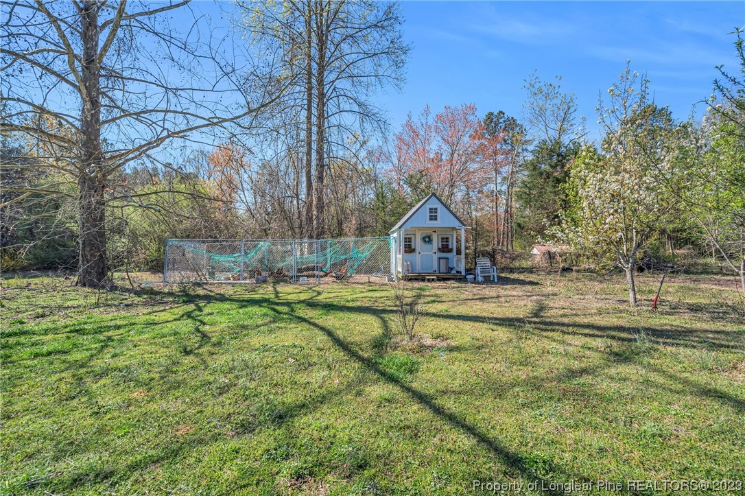 560 Moody Road Cameron, NC 28326 - Photo 21 of 29 a front view of house with yard and green space