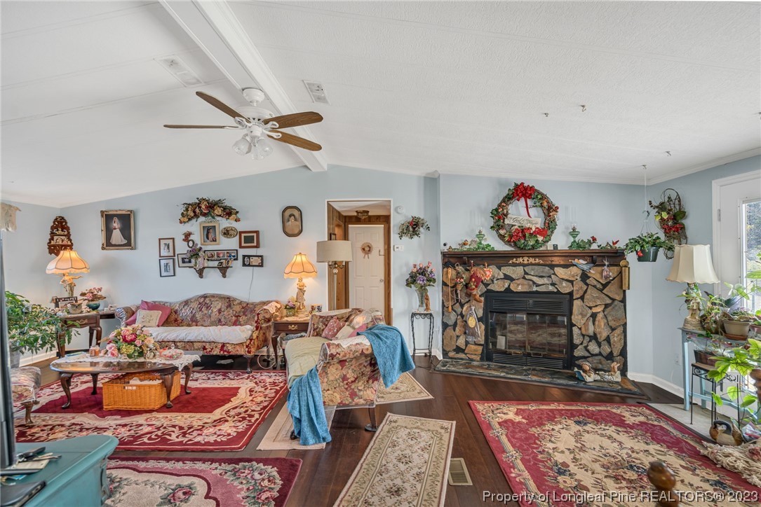 560 Moody Road Cameron, NC 28326 - Photo 4 of 29 a living room with furniture a rug and a fireplace