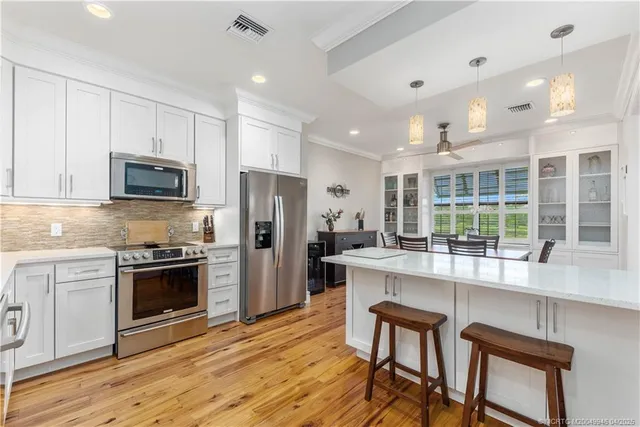 a kitchen with stainless steel appliances granite countertop a stove and a refrigerator