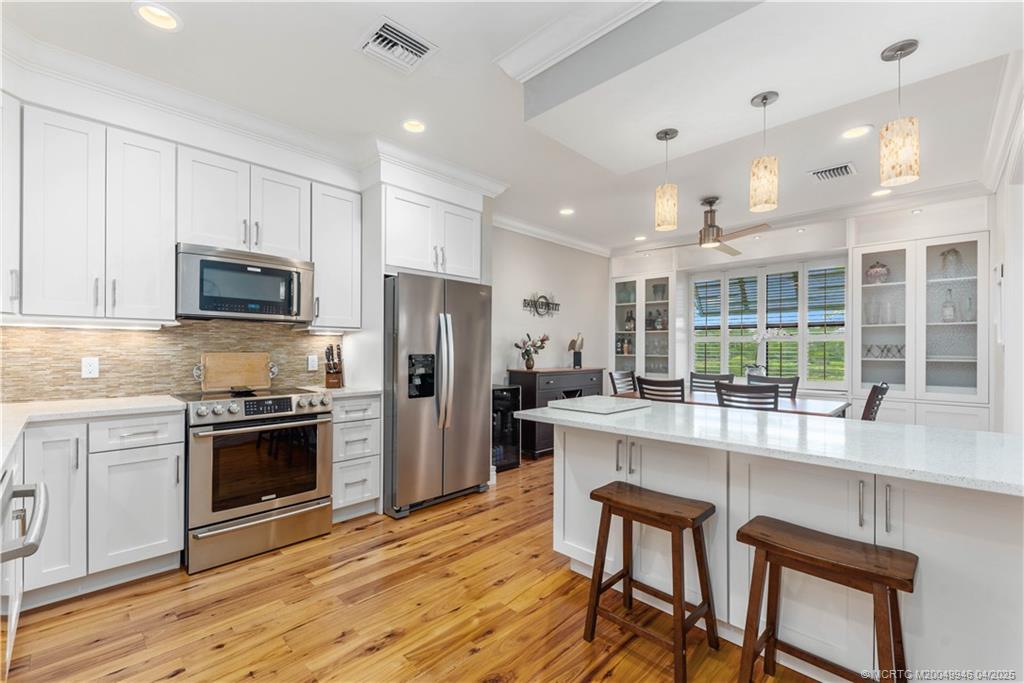 a kitchen with stainless steel appliances granite countertop a stove and a refrigerator