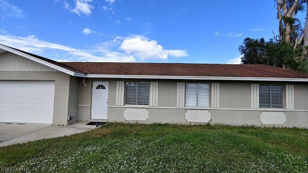 7409 Pebble Beach Road Fort Myers, FL 33967 - Photo 1 of 11 a house with yard in front of it