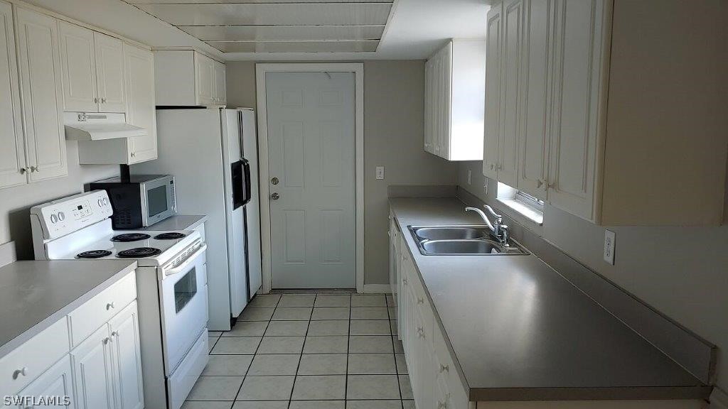 7409 Pebble Beach Road Fort Myers, FL 33967 - Photo 5 of 11 a kitchen with stainless steel appliances granite countertop a sink stove and refrigerator