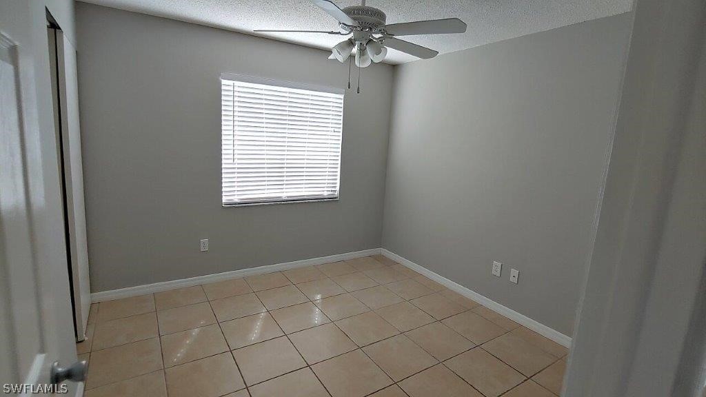 7409 Pebble Beach Road Fort Myers, FL 33967 - Photo 9 of 11 an empty room with windows and fan