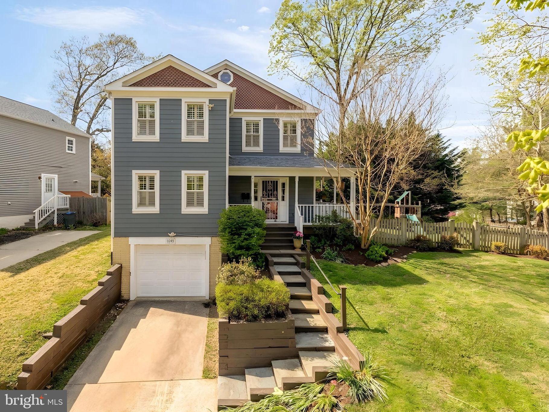Charming blue home with lush greenery.
