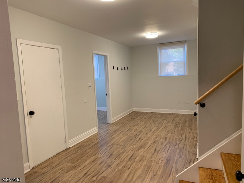 1072 Springfield Avenue New Providence, NJ 07974 - Photo 16 of 20 a view of an empty room with wooden floor and a window