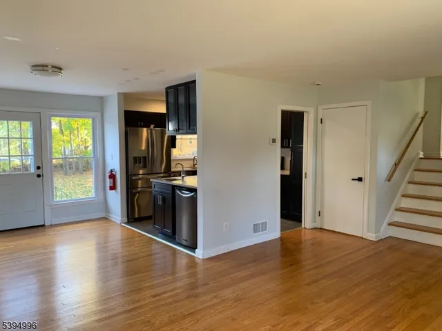 a view of a kitchen cabinets and wooden floor