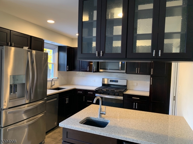 1072 Springfield Avenue New Providence, NJ 07974 - Photo 5 of 20 a kitchen with stainless steel appliances a sink stove and refrigerator