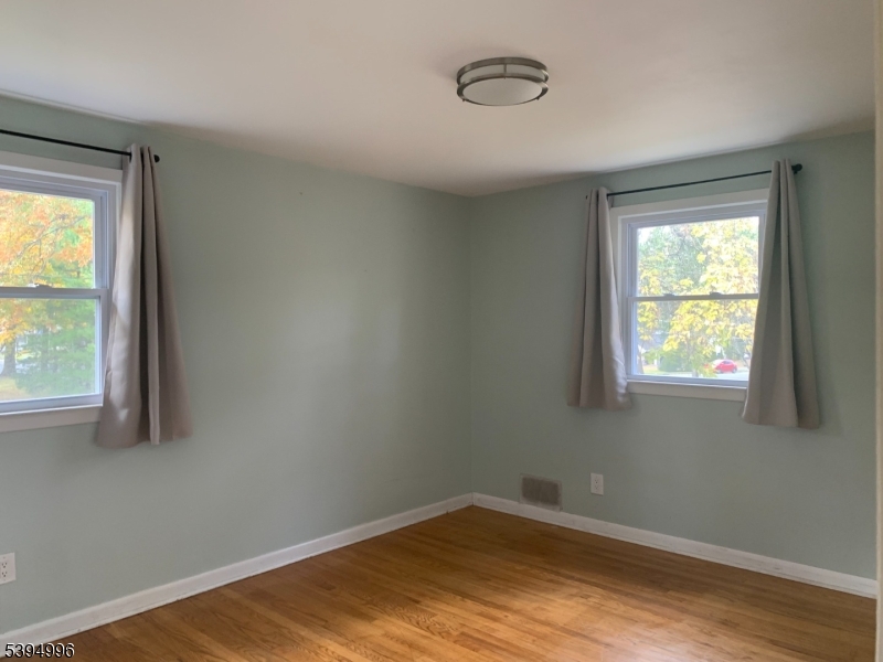1072 Springfield Avenue New Providence, NJ 07974 - Photo 8 of 20 an empty room with wooden floor and windows
