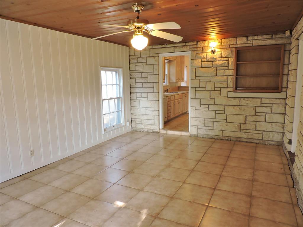 3425 Westcliff Road South Fort Worth, TX 76109 - Photo 19 of 22 Spare room with wooden ceiling, light tile patterned floors, and a ceiling fan