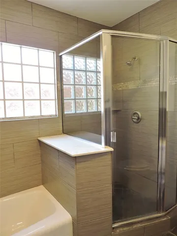 a bathroom with a bathtub and shower