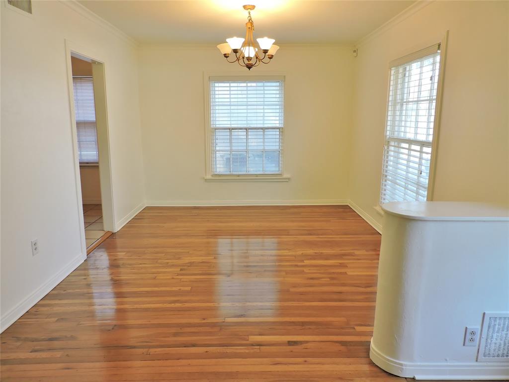 3425 Westcliff Road South Fort Worth, TX 76109 - Photo 4 of 22 Unfurnished dining area featuring healthy amount of natural light, light wood-style floors, crown molding, and a chandelier