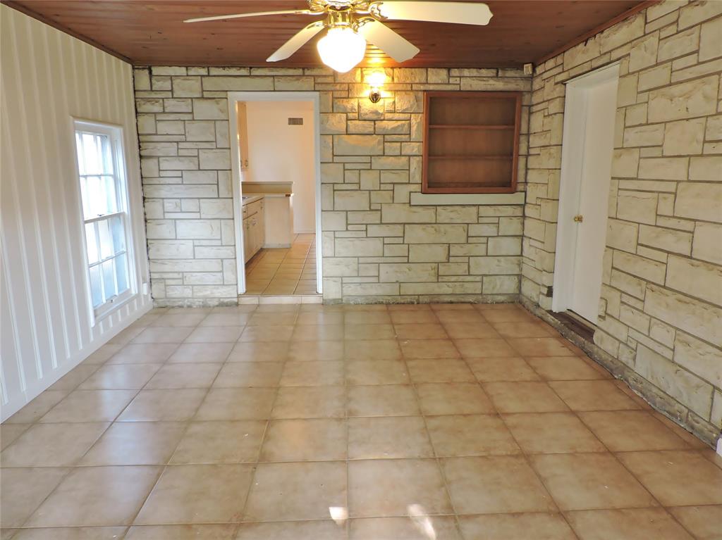 3425 Westcliff Road South Fort Worth, TX 76109 - Photo 7 of 22 Kitchen with white fridge with ice dispenser, light countertops, light brown cabinets, and light tile patterned floors